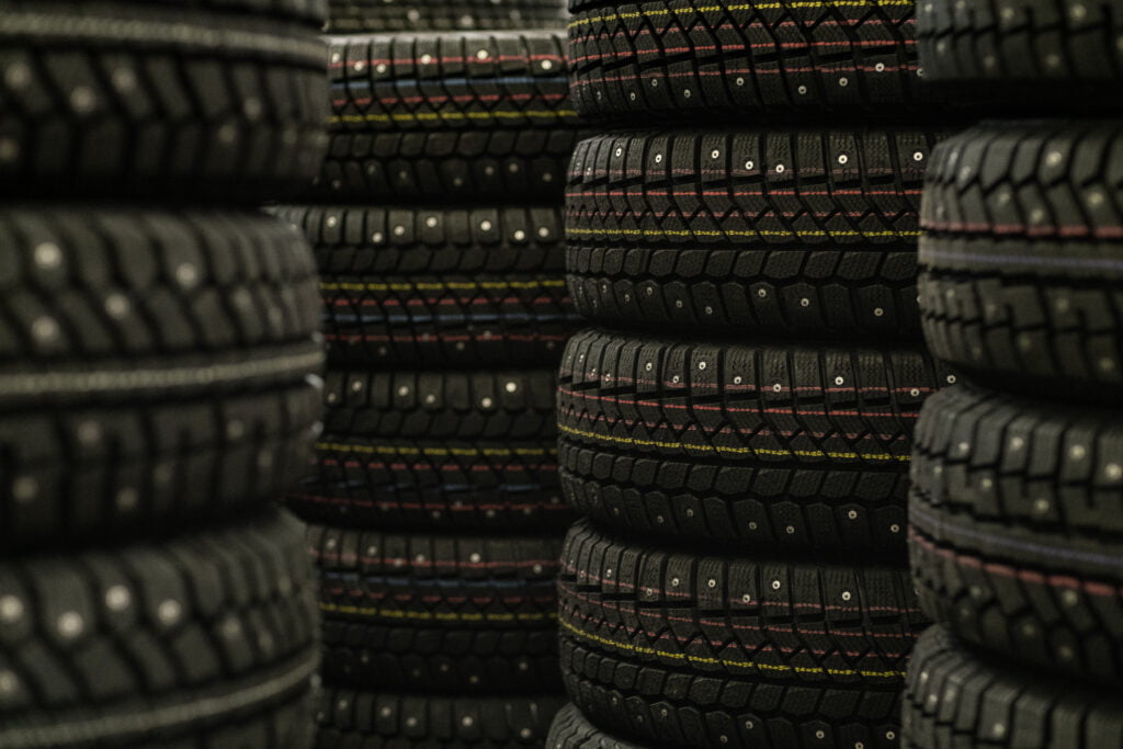 Sale of car tires for sale in the store. Many new winter tires lie