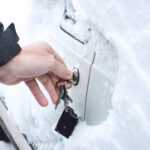 Ways to Open Frozen Car Doors. heating up the key. Male hand opening winter car door with keys