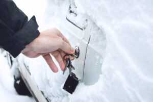 Ways to Open Frozen Car Doors. heating up the key. Male hand opening winter car door with keys